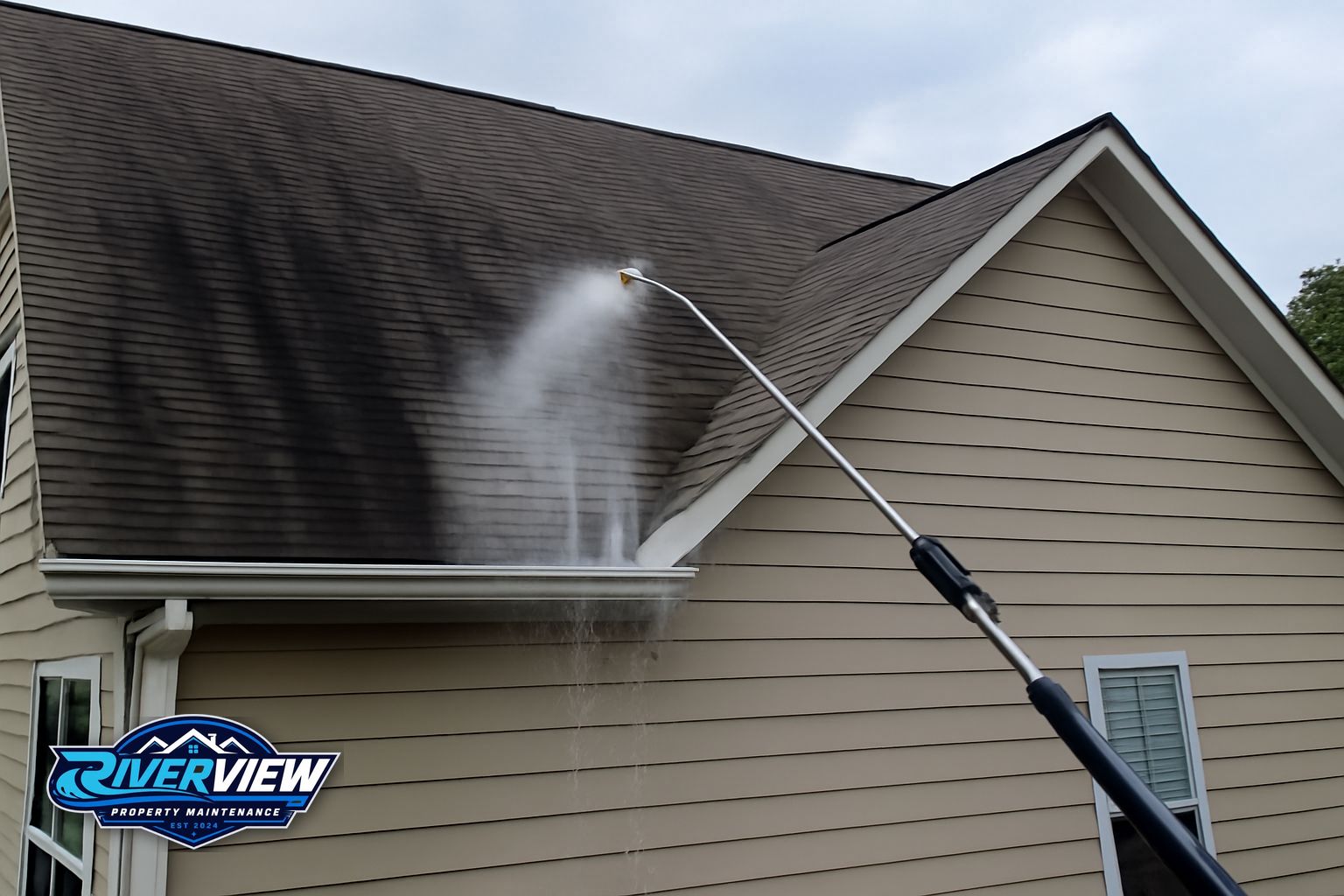 Roof soft washing removing black algae streaks from asphalt shingles on a Lawrenceville GA home