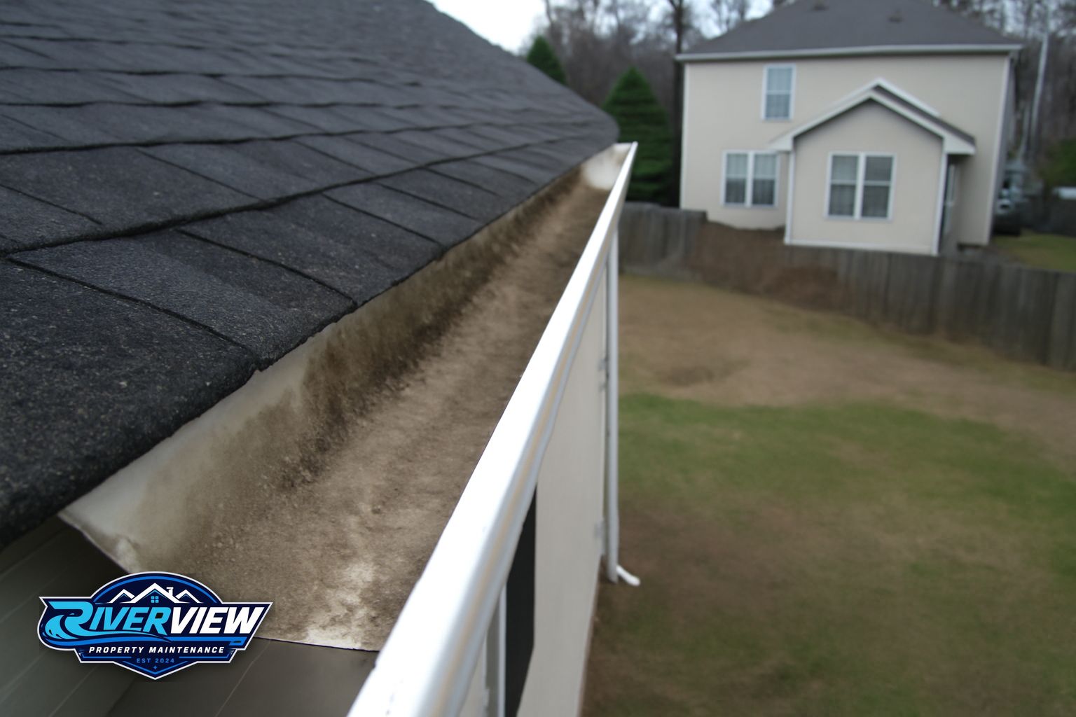 Black algae streaks on asphalt shingles on an Auburn Georgia home before soft washing