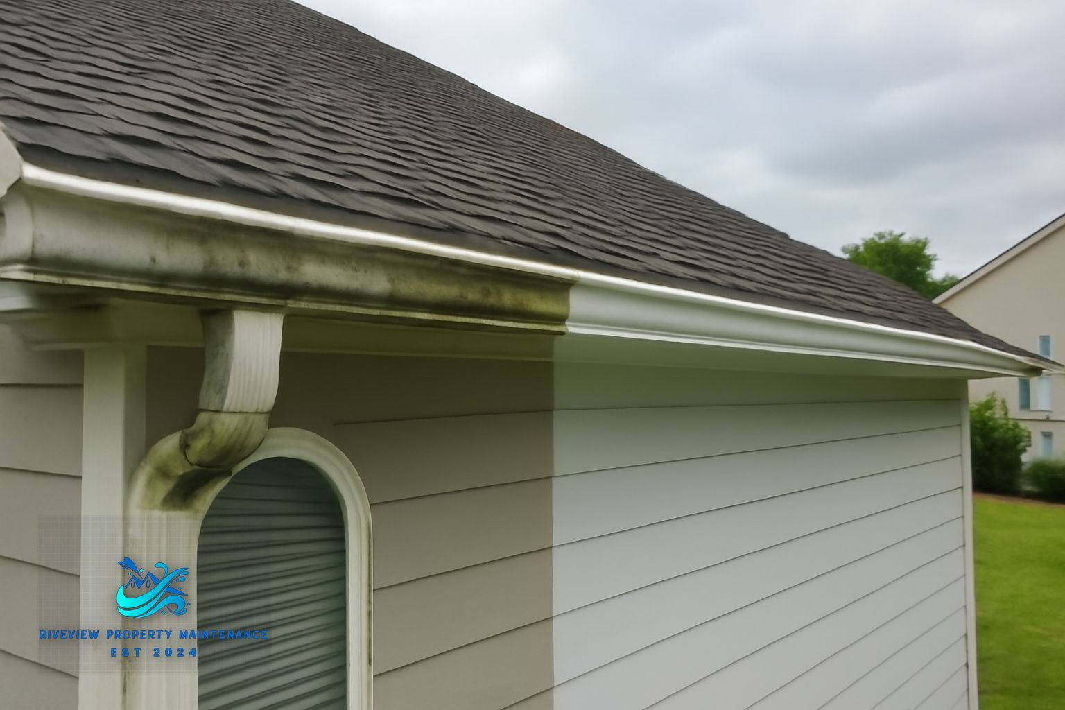 Gutter packed with pine needles and compacted Georgia clay debris on a Gwinnett County home
