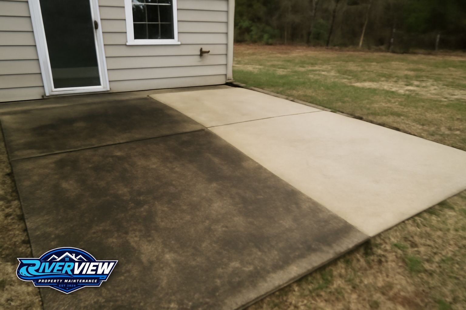 Pressure washing a concrete driveway in Winder, GA removing red clay and mildew stains