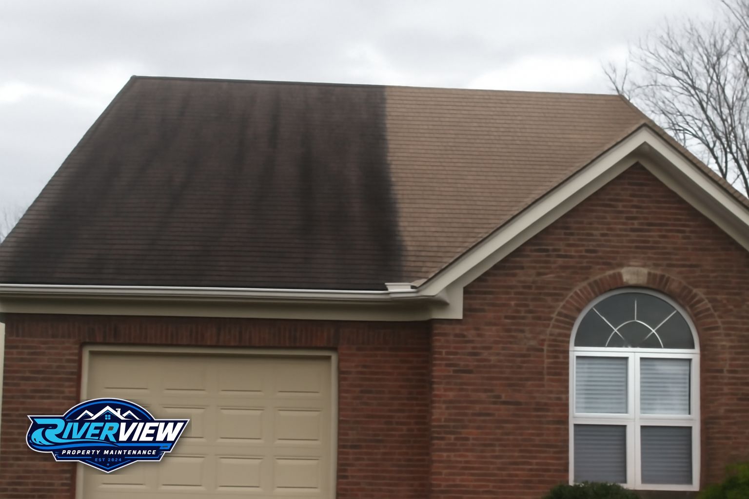 Dark algae streaks running down an asphalt shingle roof in Winder, GA before soft washing treatment