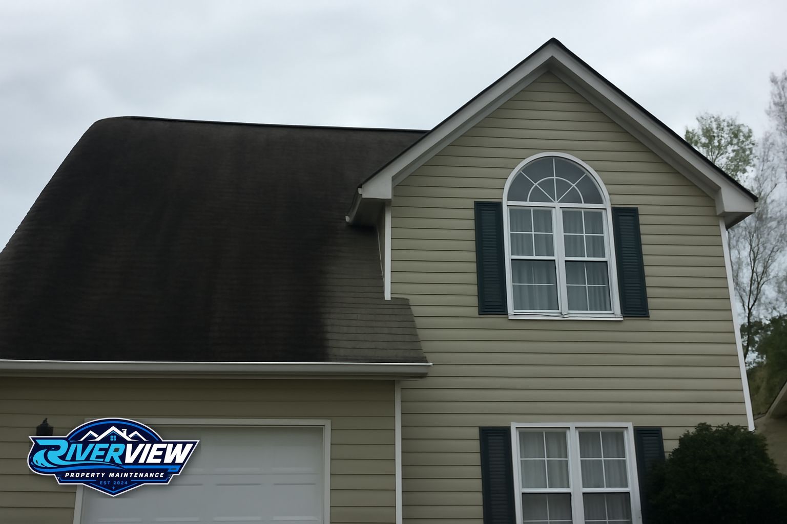 Dark algae streaks on an asphalt shingle roof in Dacula, GA before soft washing