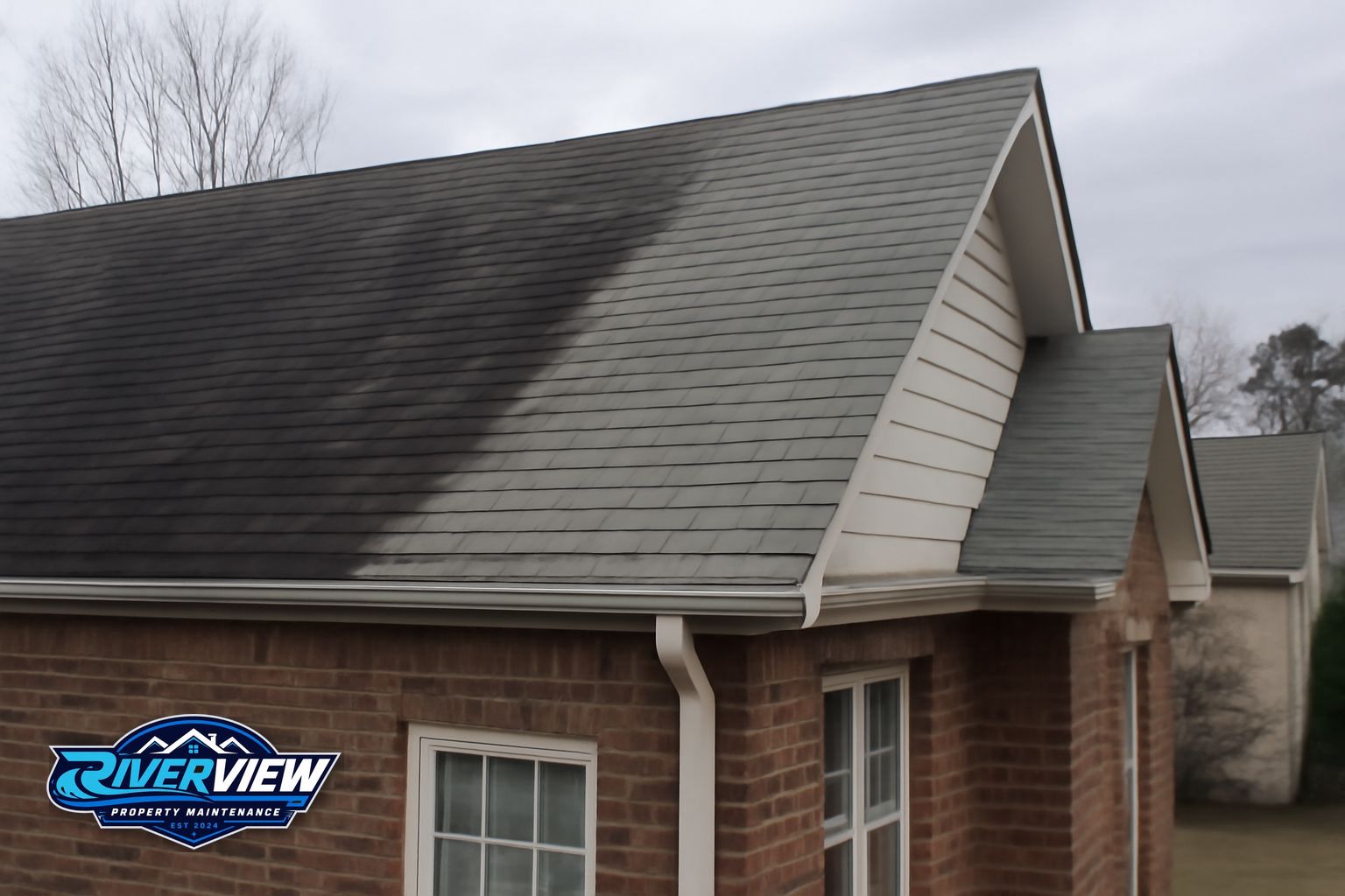 Riverview Property Maintenance crew soft washing a residential roof in Gwinnett County Georgia