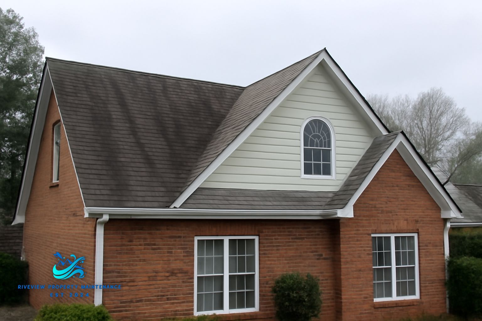 Black algae streaks on asphalt shingles in Lawrenceville, GA before soft washing