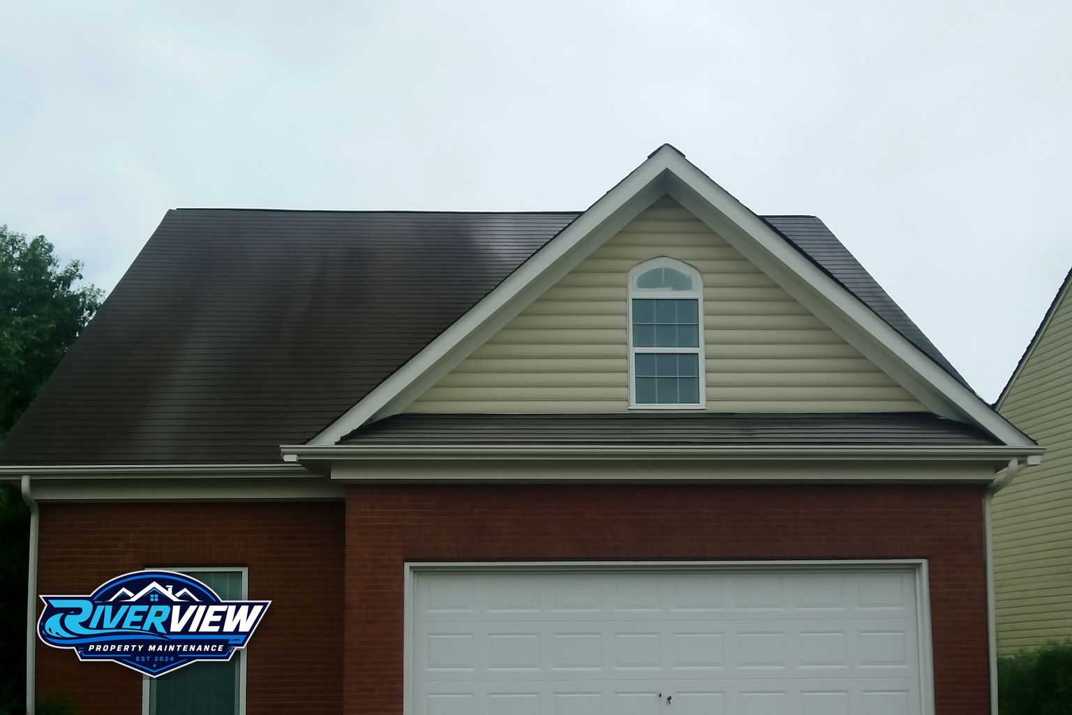 Black algae streaks on asphalt shingles before soft washing in Lawrenceville, GA