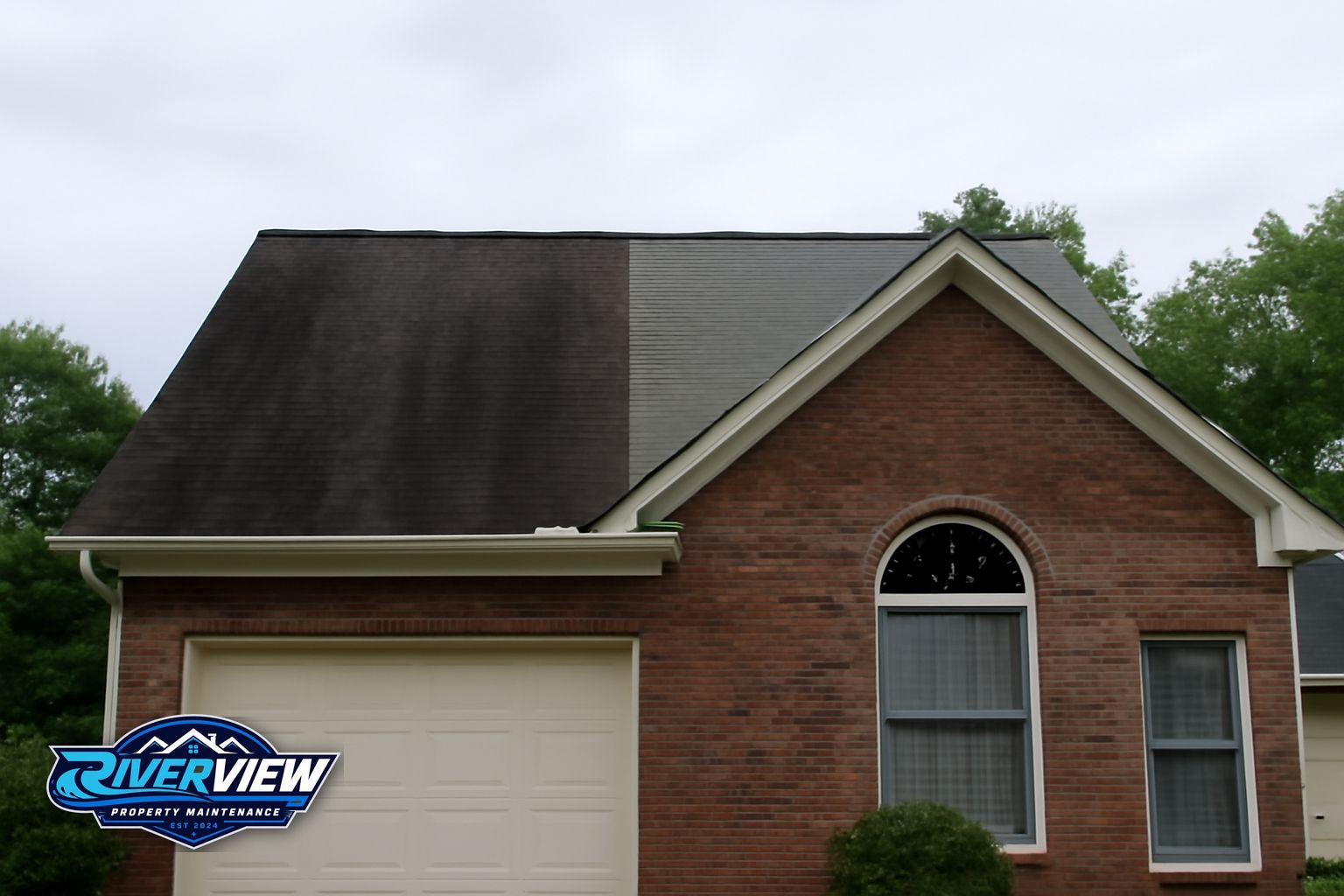 Black algae streaks on an asphalt shingle roof in Lawrenceville, GA before soft washing treatment