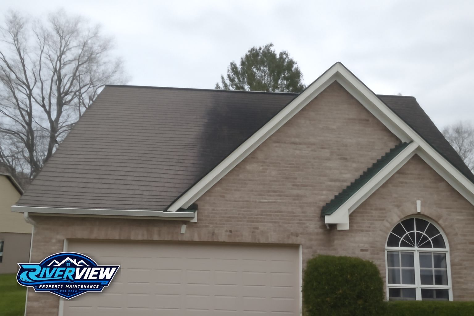 Riverview Property Maintenance technician soft washing a home exterior in Lawrenceville, GA