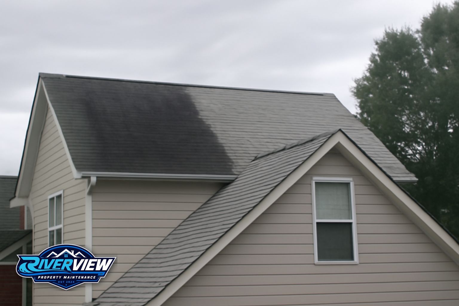 Riverview Property Maintenance soft washing a two-story home exterior near Loganville Georgia including roof and siding