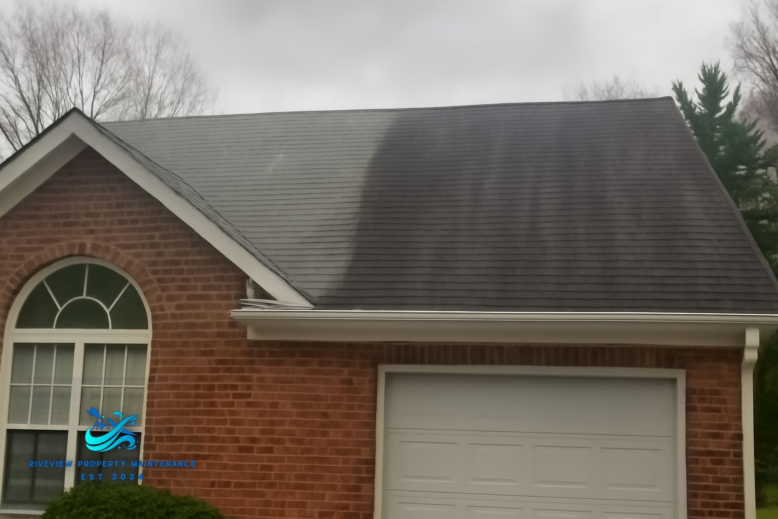 Riverview Property Maintenance technician applying soft wash solution to a roof in Gwinnett County, GA