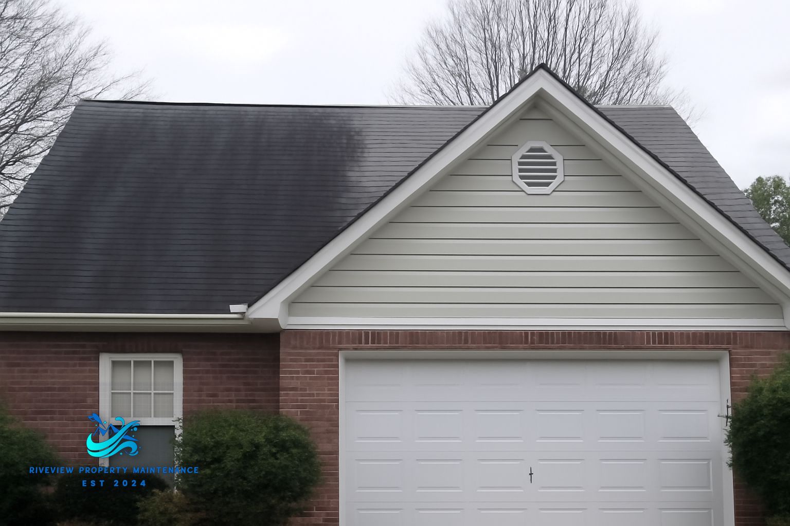 Black algae streaks on asphalt shingles on a Gwinnett County home before soft washing