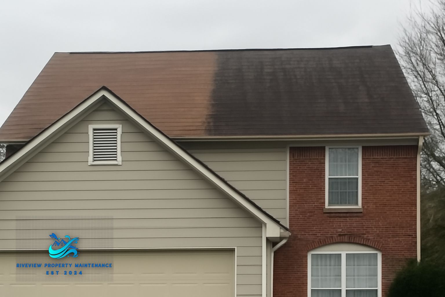 Crew member rinsing foundation plantings before roof soft washing on a Gwinnett County home