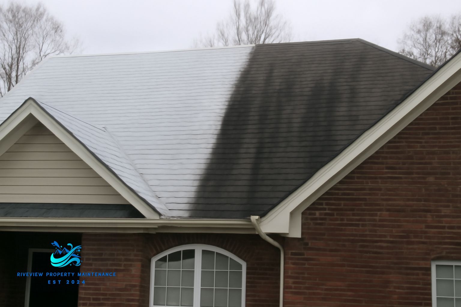 Riverview Property Maintenance technician applying soft wash solution to a shingle roof in Winder Georgia